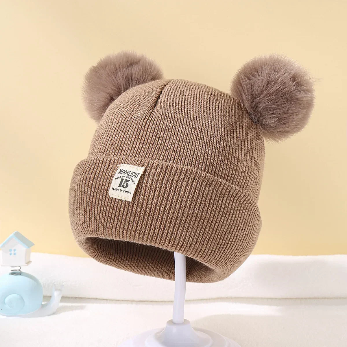 Baby hat with pompoms