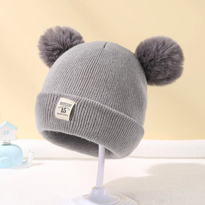 Baby hat with pompoms