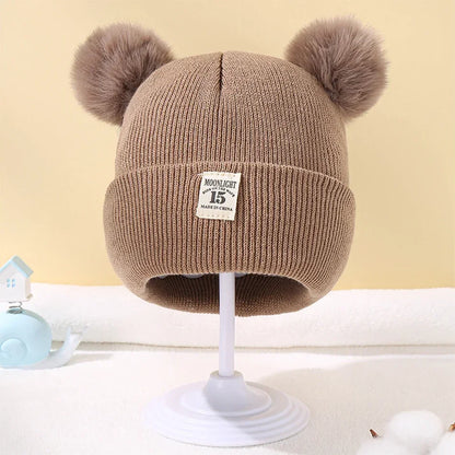 Gorro de bebé con pompones