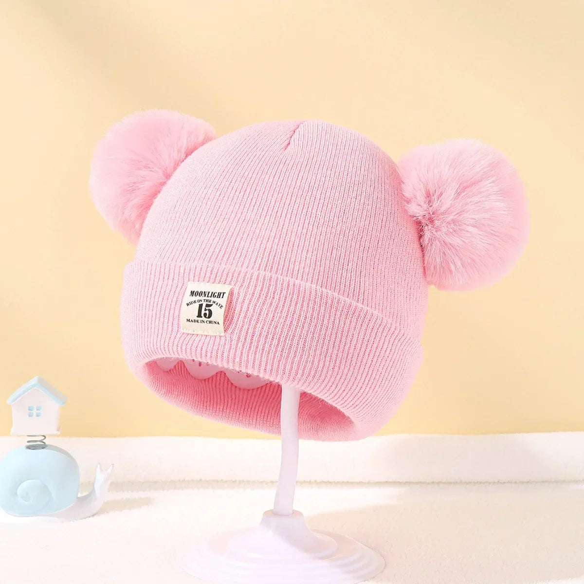 Gorro de bebé con pompones